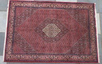 A Persian Bidjar rug, salmon pink ground with central cream medallion