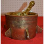 A 17th century style brass mortar spaced with six spines with brass pestle 14.5 cm diam.