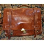 A brown leather briefcase branded "Three Bags"