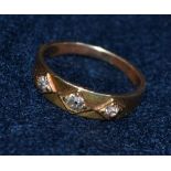 A Victorian three-stone diamond ring, the yellow metal band tested as 18ct , gross weight: 2.9g, rin