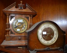 An oak bracket clock with another similar example