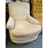 A pair of upholstered tub chairs in beige fabric