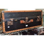 A black leather edged traveling trunk