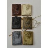 A collection of six grand tour carved lava panels, classical mask decoration, each yellow metal fram