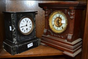 A black marble mantle clock with a wooden example