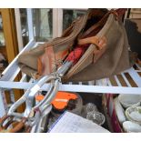 A canvas holdall containing cartridge belts with a umbrella seat-stick