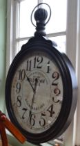 A large decorative wall clock shaped like a pocket watch
