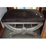 A modern black upholstered silver painted stool