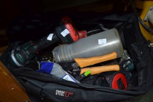 A holdall bag containing a Parkside battery drill and other hand tools