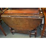 A Georgian small oval oak drop-leaf table 91 cm