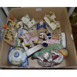 A box contains 19th century Staffordshire pottery figures and cottages