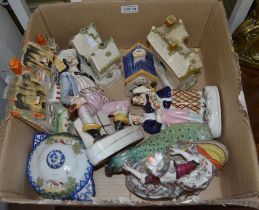 A box contains 19th century Staffordshire pottery figures and cottages