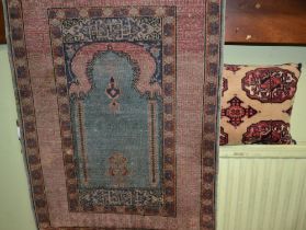 Silk woven prayer rug with much script to boarder sold with a carpet cushion