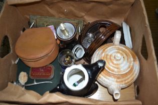 A box containing mixed domestic items in a variety of medium