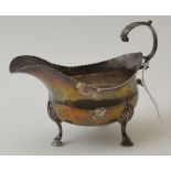 Joshua Jackson, a George III silver sauce boat, with scroll handle raised on three supports, London