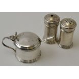 William Adams Ltd. A three-piece silver condiment set, comprising salt & pepper shakers, a drum must