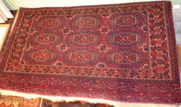 A Tekke Turkoman tent panel, red ground with elephant foot design, fringed on one side, 144cm x 80cm