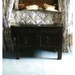 A late 17th century oak chest, the twin panel top, foliate arcaded top rail and two similar panels,