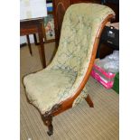 A Victorian carved framed nursing chair in green upholstery