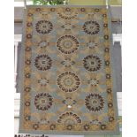 A modern pulled wool blue ground geometric patterned conservatory carpet