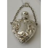 Considered to be Reynolds & Westwood, an Edwardian silver embossed heart shape scent bottle on suspe