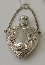 Considered to be Reynolds & Westwood, an Edwardian silver embossed heart shape scent bottle on suspe