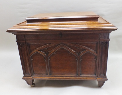 A Victorian oak Gothic Revival cellarette, having cavetto moulded caddy top, the front and sides mou