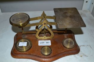 A vintage set of brass and wooden postage scales