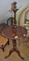 A reproduction mahogany tripod lamp with table top