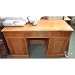 A well made light oak twin-pedestal desk 121 x 43 x 79 cm