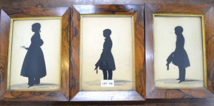 A suite of three 19th century full length painted silhouettes in period rosewood frames