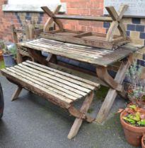 A 'Woodfurn' teak garden set, comprising table on X form supports, 150cm x 74cm together with a pair