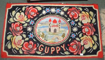 A rag rug with rose and castle barge type decoration, inscribed "Guppy", 70cm x 128cm