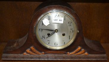 An oak cased mantel clock