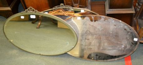 Four early 20th century oval wall mirrors