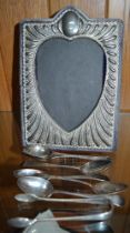 A silver plated photograph frame, together with hallmarked silver spoons , sugar nips, and one other