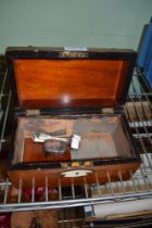 A 19th century tea caddy in the form of a treasure chest containing three silver spoons and a silver