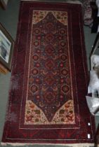 An Eastern wool rug, blue and cream ground with bird and floral motifs, crimson border and fringe 20