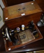 A Naumann sewing machine in wooden carry case