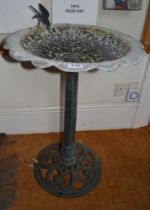 A cast metal bird bath, floral bowl top with bird figure to rim