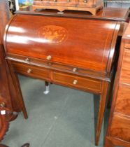 An Edwardian mahogany barrel topped writing unit with slide out compartmentalised interior over two