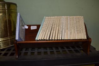 A wooden book trough containing Beatrix Potter stories etc