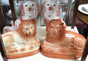 A pair of pottery mantel dogs, together with a pair of pottery lions