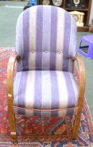 An open armchair with steam bent arms upholstered in a stripe fabric