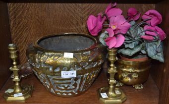 A pair of 19th century brass candlesticks 15 cm high and a shell in a brass planter