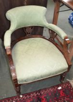 A 19th century carved wooden framed horseshoe backed low chair, with green damask upholstered back &