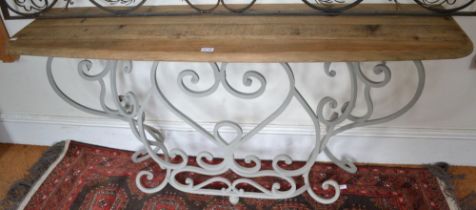 A scrub top console table on grey painted wrought metal base