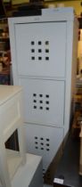 A white finished free-standing four box storage tower