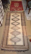 Two geometric patterned rugs one beige one red