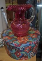 A useful and decorative hat box and a 'cranberry' glass jug